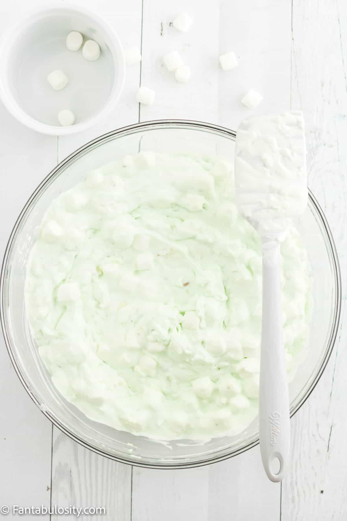 whipped topping added to mixture in glass bowl