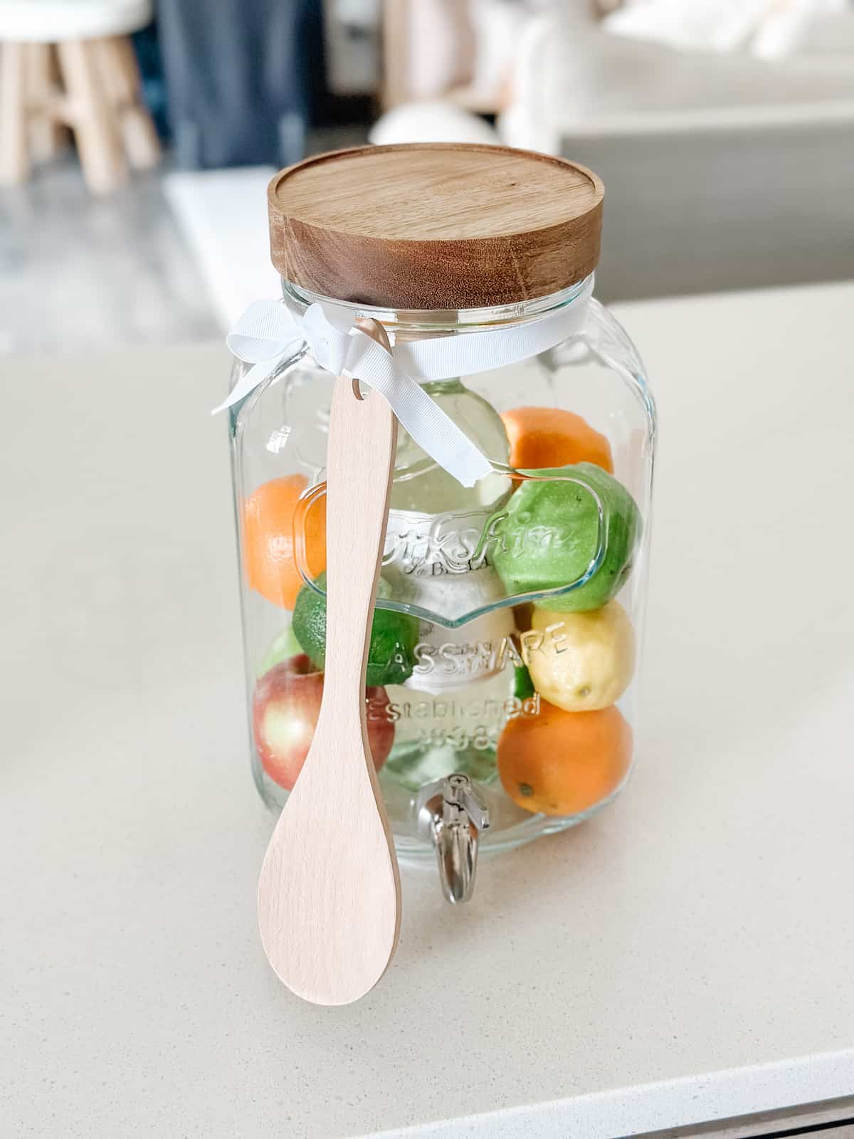 DIY Sangria kit with drink dispenser on white counter.