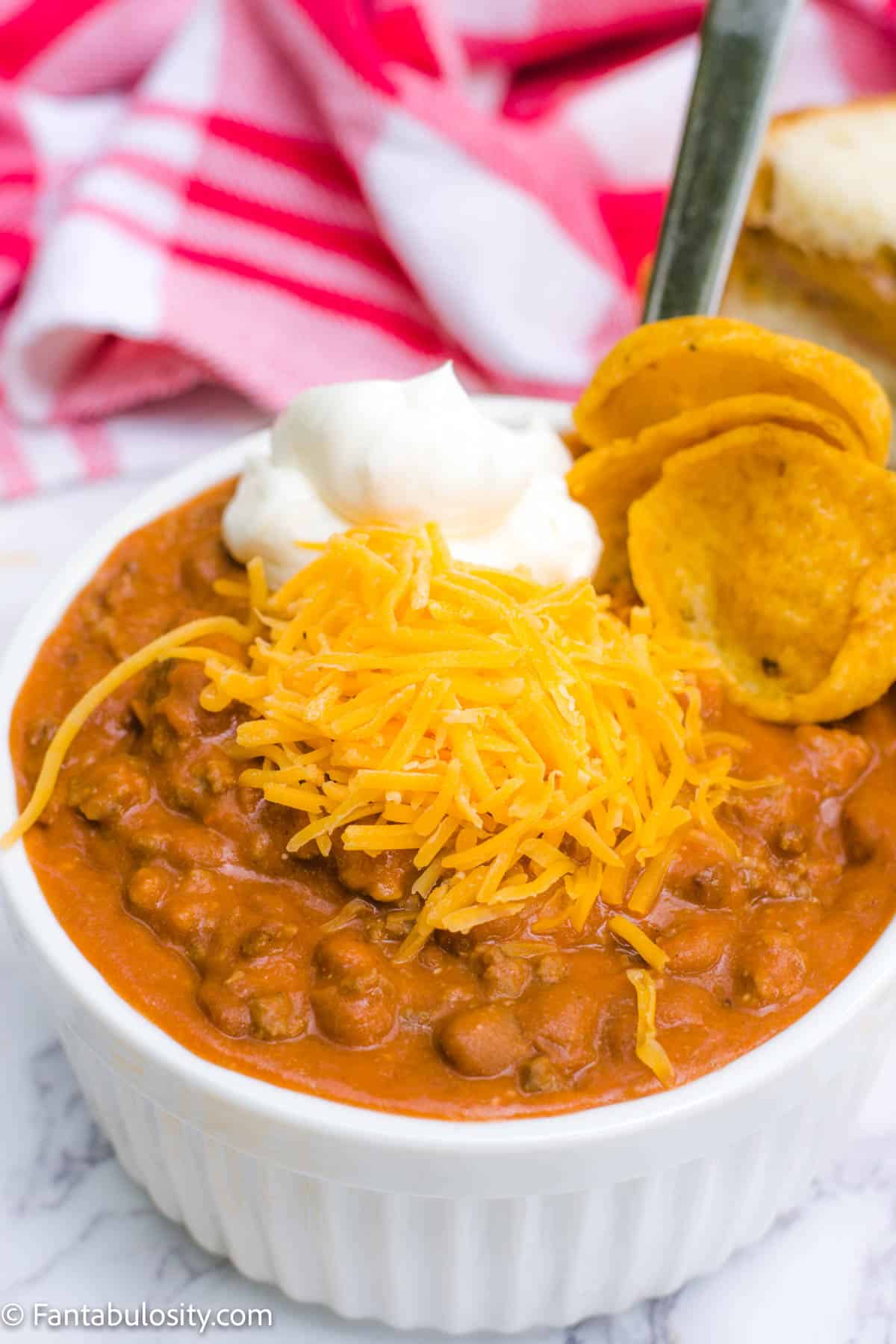 Easy Chili with cheese, fritos and sour cream