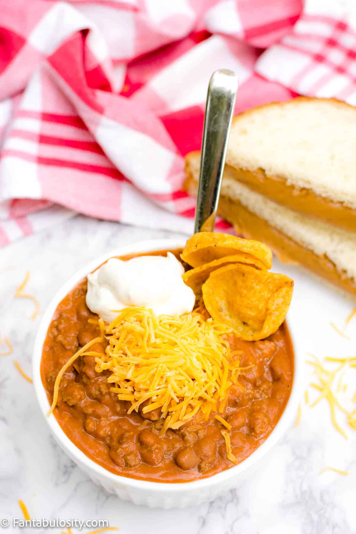 Chili with cheese, sour cream and fritos
