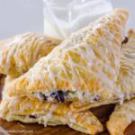 Blueberry turnovers with a powdered sugar and milk glaze.