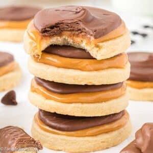 Stack of Twix cookies on white marble counter.