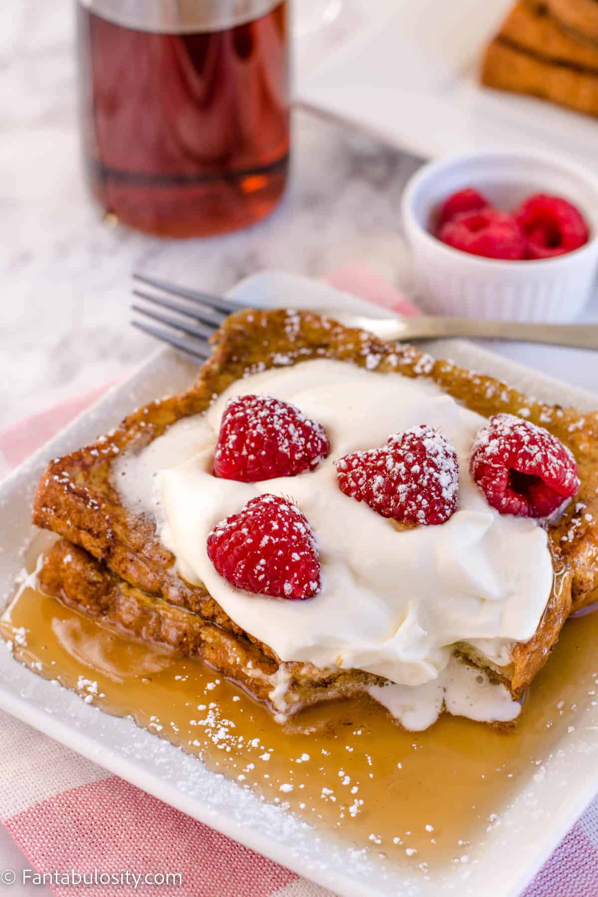 2 slices of brioche french toast on white plate