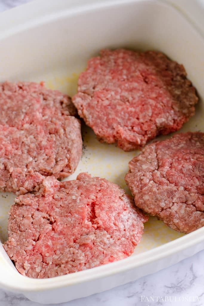 Flip the seasoned burgers over in to the baking dish and season the other side