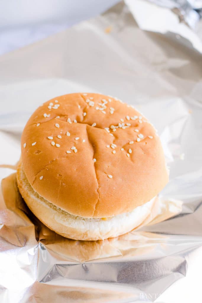 Build the cheeseburger and wrap in aluminum foil