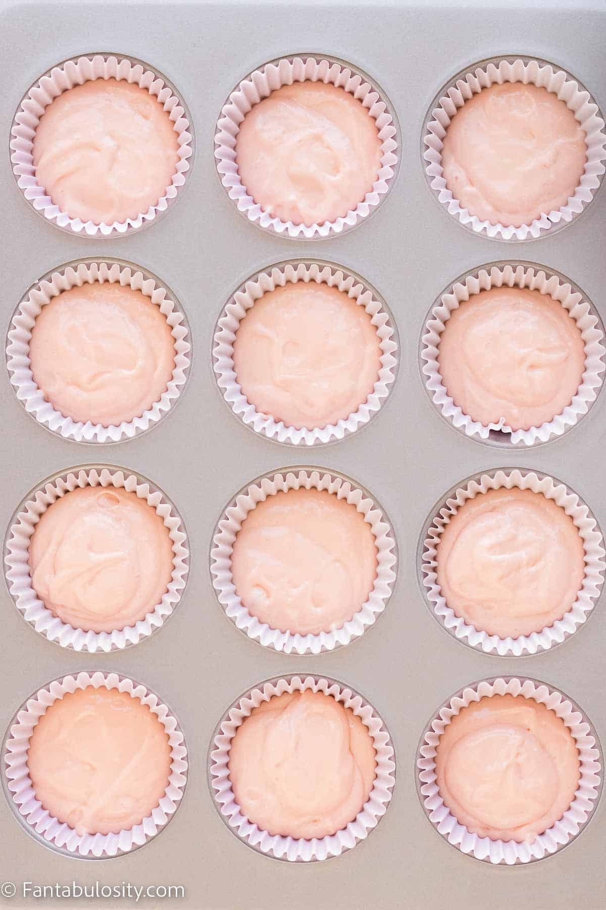 Pink champagne cupcakes in baking pan.