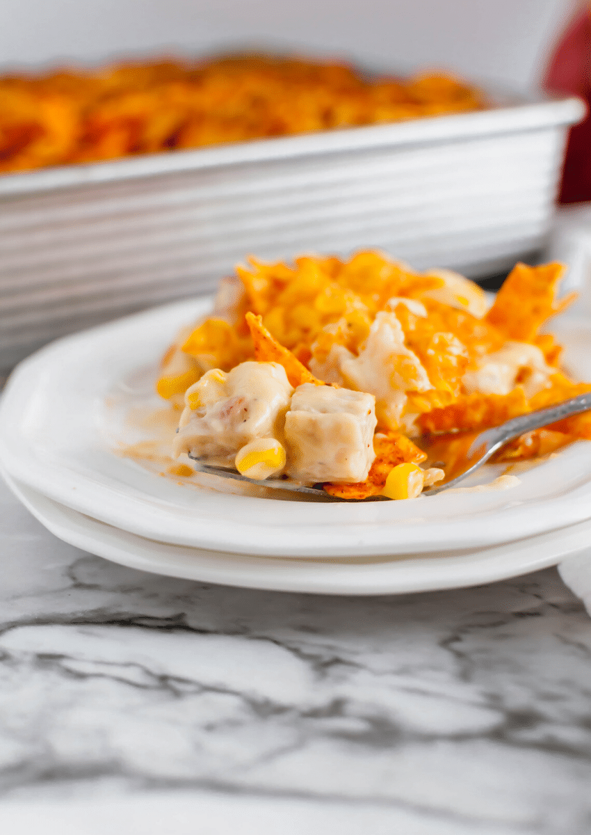 The Easy Dorito Chicken Casserole is made with everyday ingredients like Cream of chicken soup, Sour cream, Canned corn, Ro-tel, Cooked Chicken, Shredded pepper jack cheese, Nacho Cheese Doritos #doritos #casserole #chicken