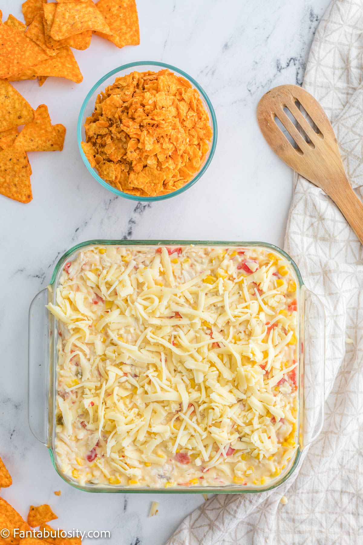 Top Doritos chicken casserole with shredded cheese