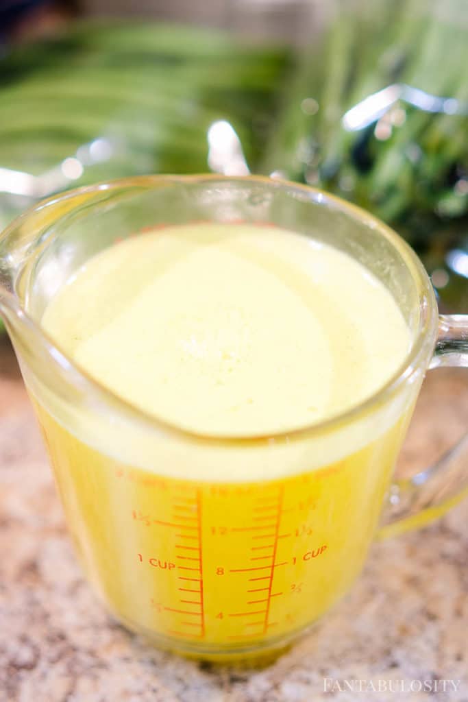 Instant chicken broth in a measuring cup for green beans