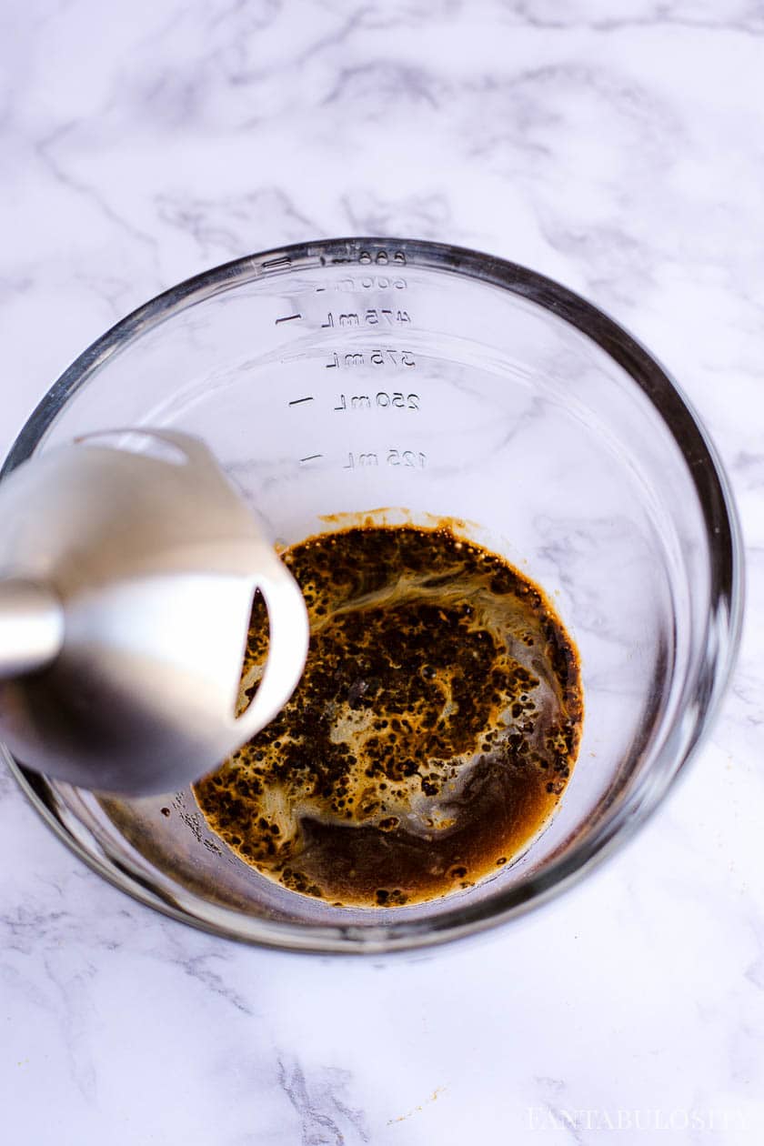 Mixing together instant coffee, sugar and water