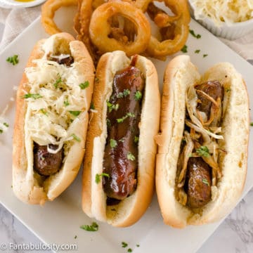 bratwursts on bun with toppings