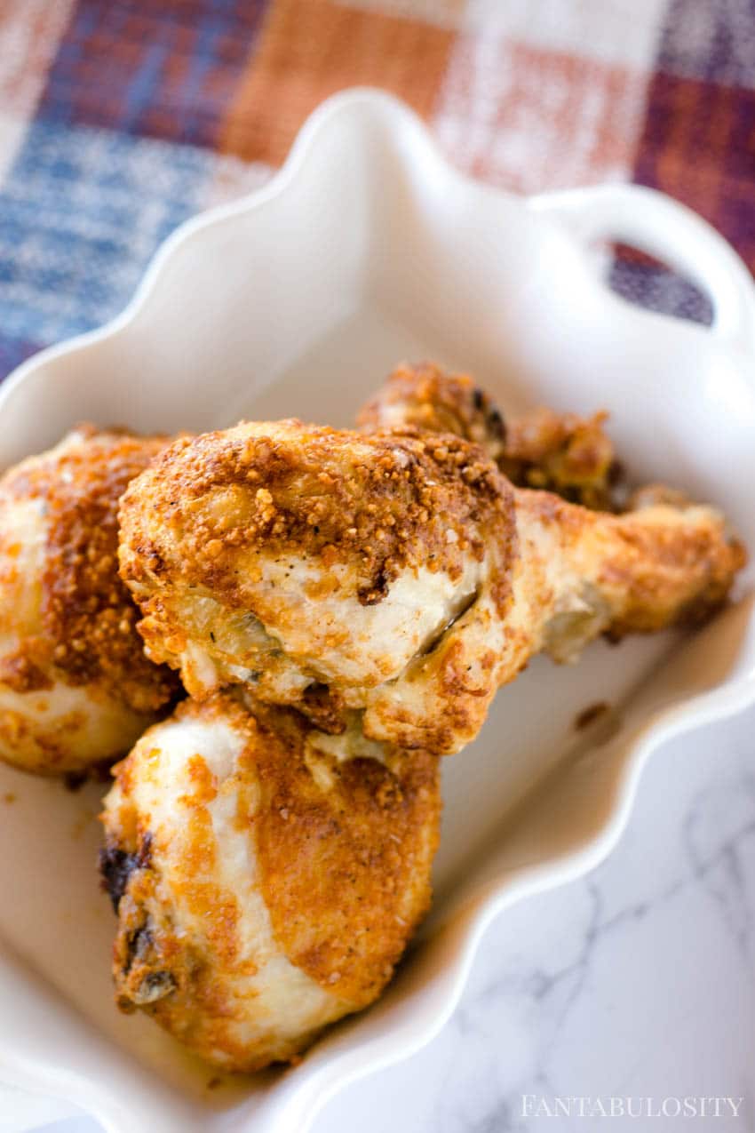 A plate of crispy air fryer chicken legs.
