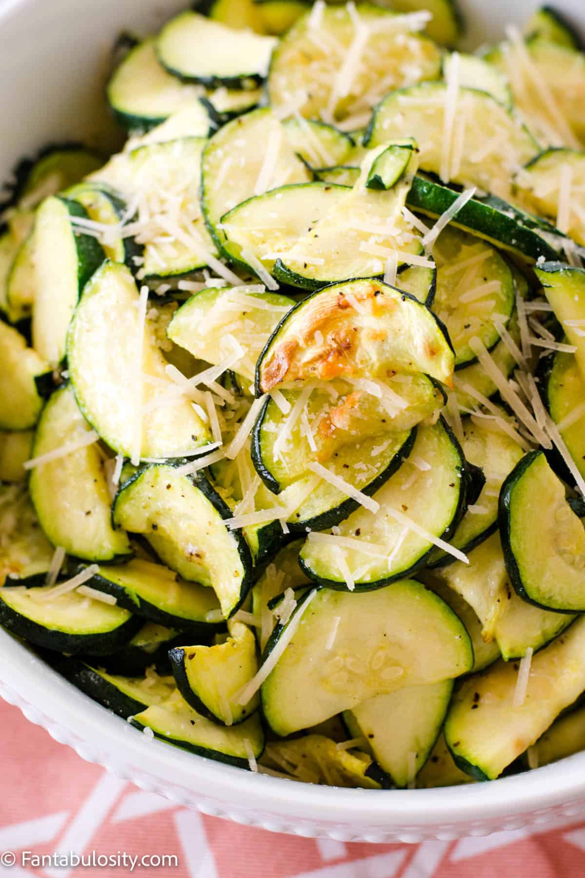 sliced, cooked air fryer zucchini in white bowl