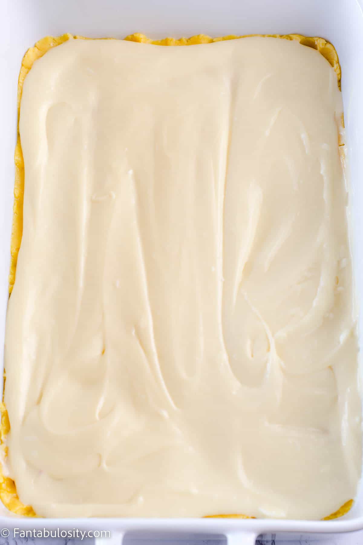 Cream cheese mixture spread evenly across cake