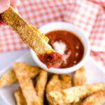 Air fryer eggplant fries dipped in marinara sauce.