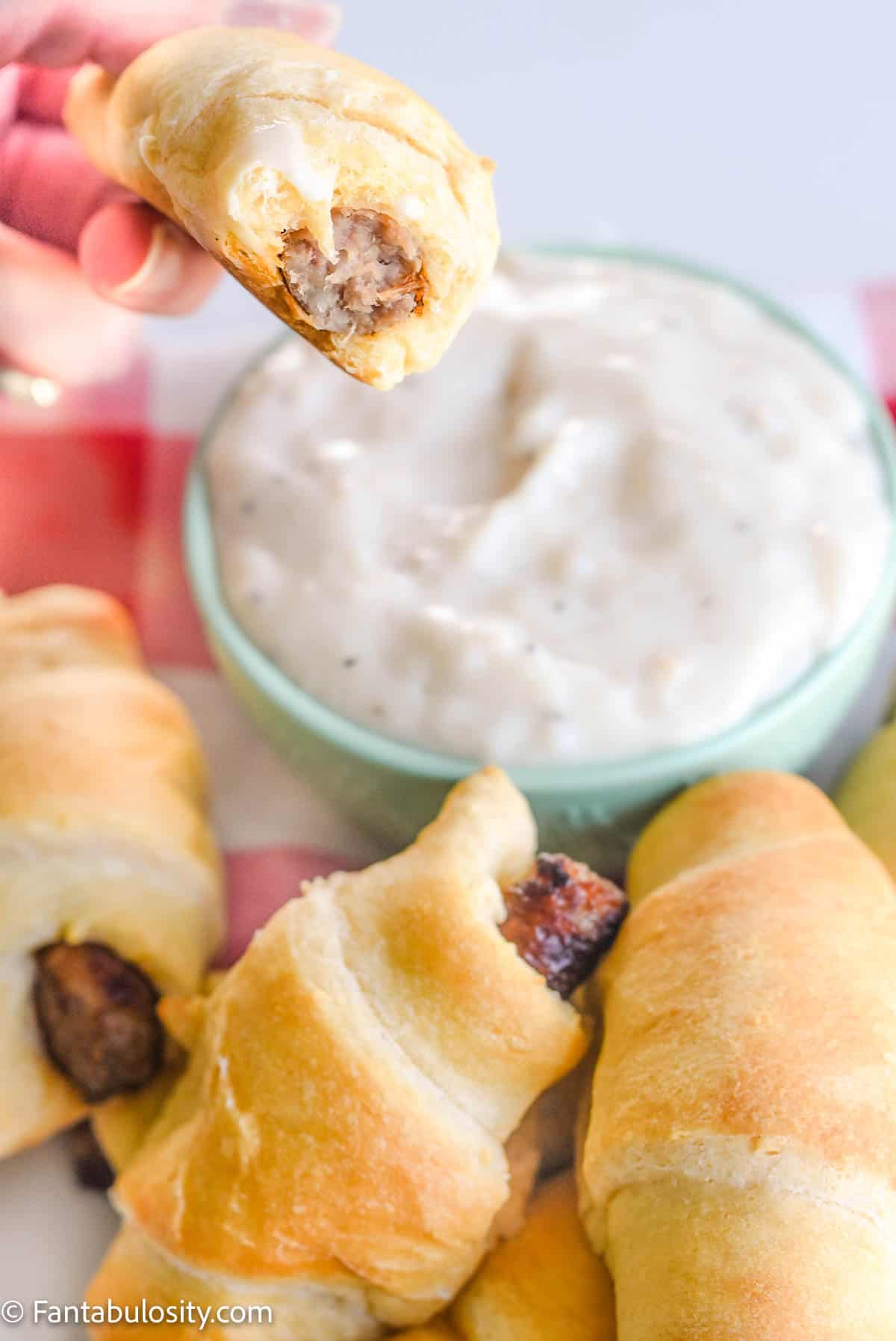 Bite taken out of crescent rolls with sausage
