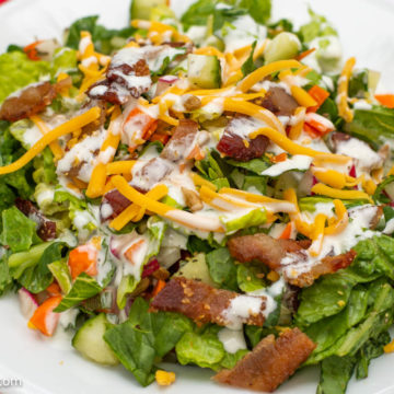 The BEST side salad recipe on a white plate and red napkin