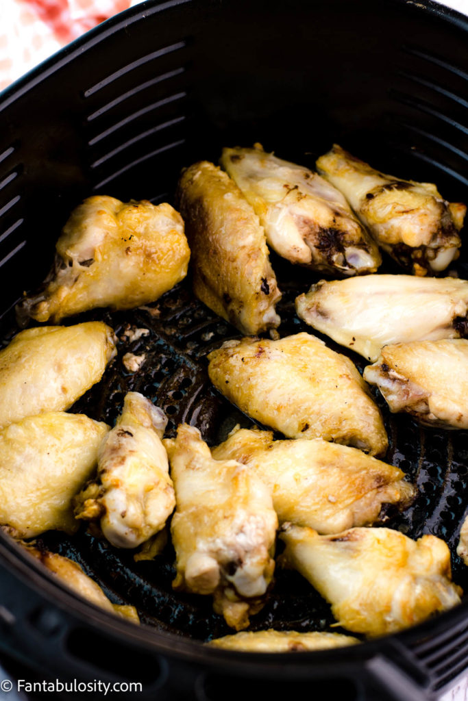 Partially cooked chicken wings in air fryer