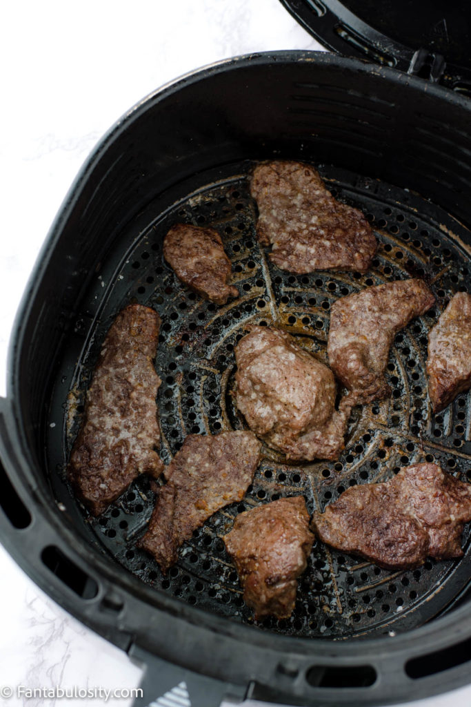 Cooked deer meat in air fryer basket, after 7 minutes