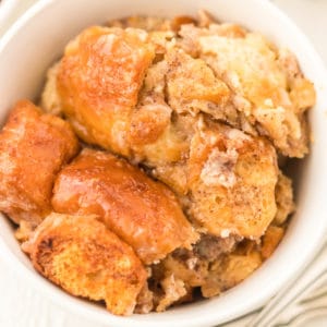 close up of donut bread pudding in white bowl