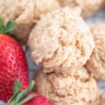 Strawberry cheesecake cookies stacked on top of one another.