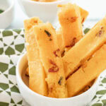 Polenta fries in a white bowl.