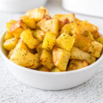 Air fryer breakfast potatoes in bowl.