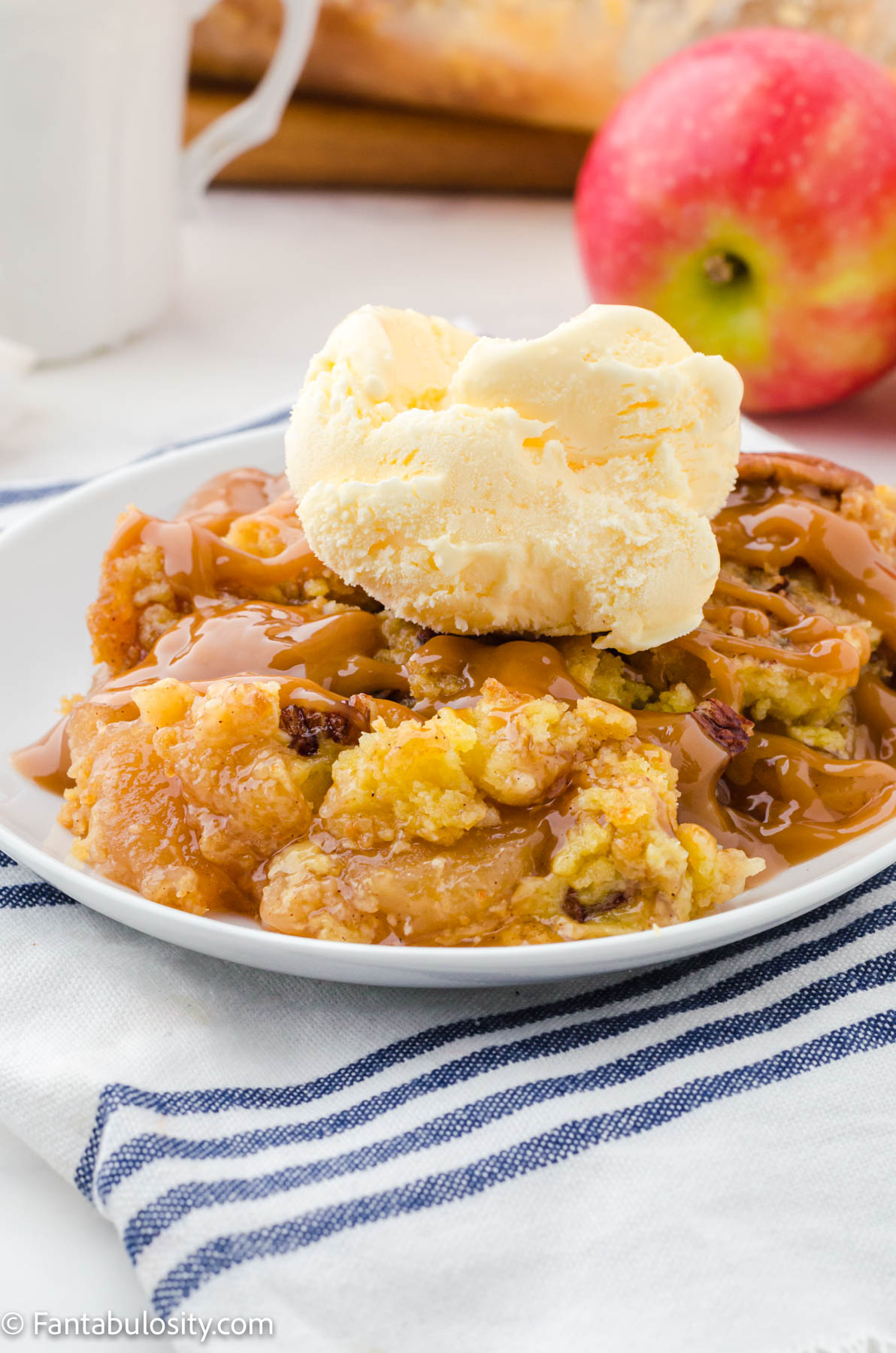 caramel apple dump cake with vanilla ice cream scoop