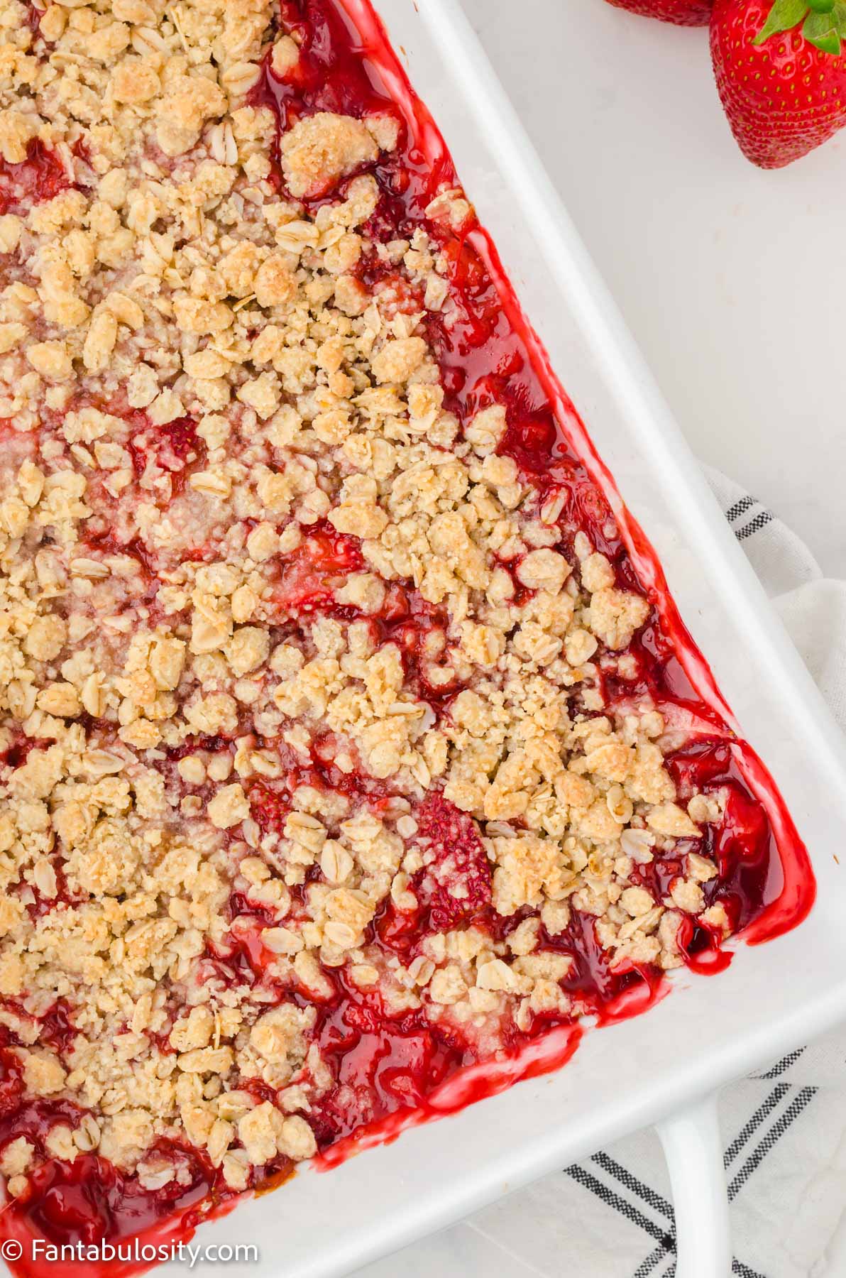 Strawberry crumble baked in white baking dish