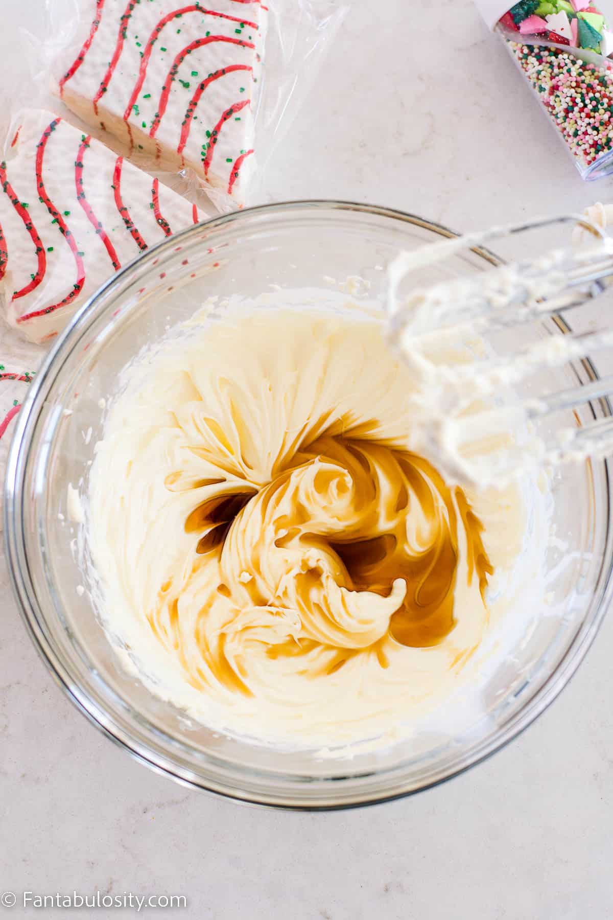 Vanilla in cream cheese mixture in glass bowl