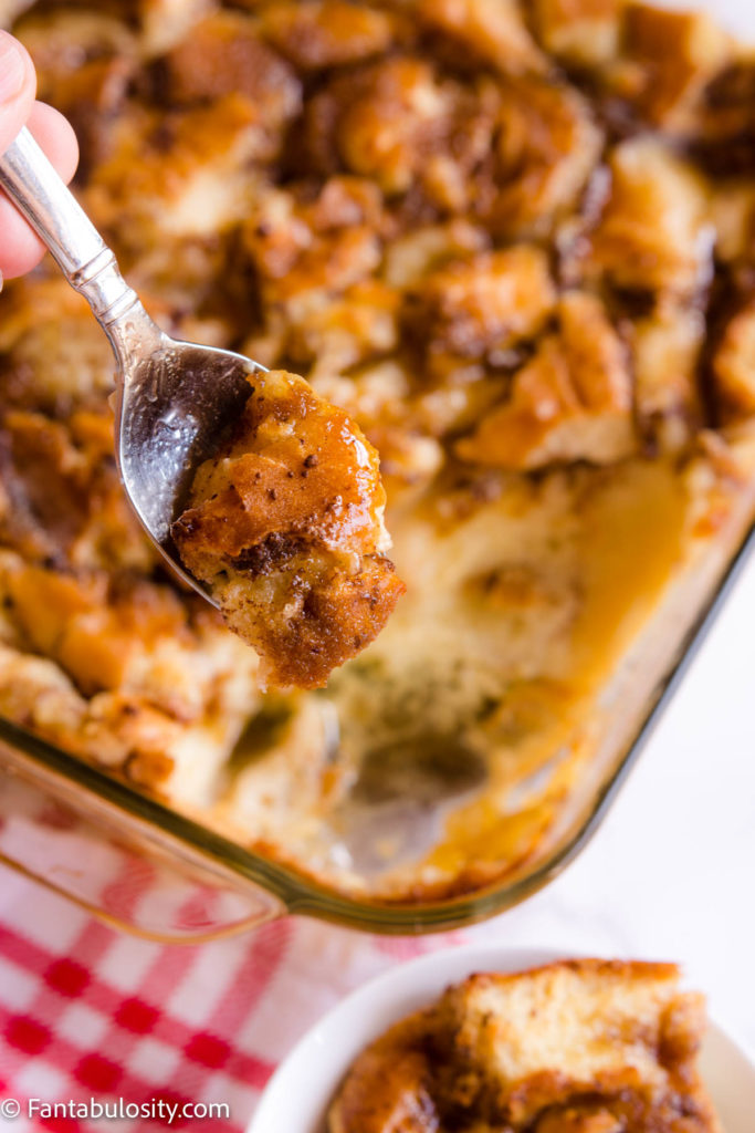 Bread pudding on a spoon over dish