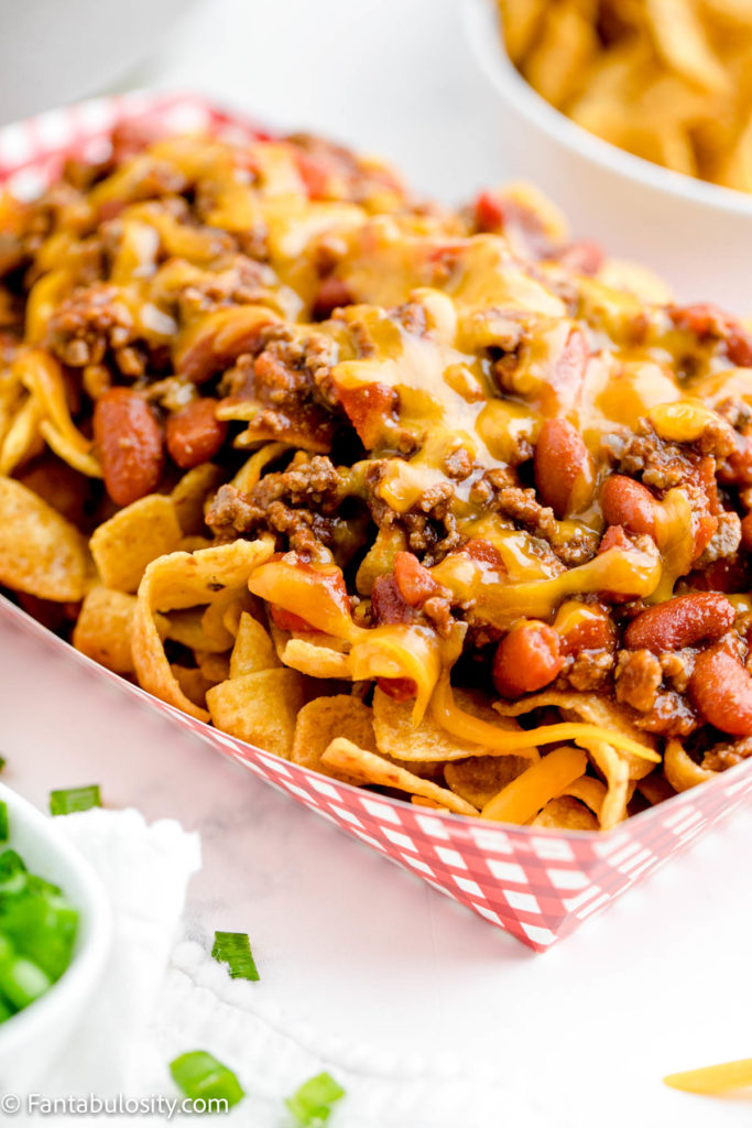 Melted cheese on frito chili pie in food boat