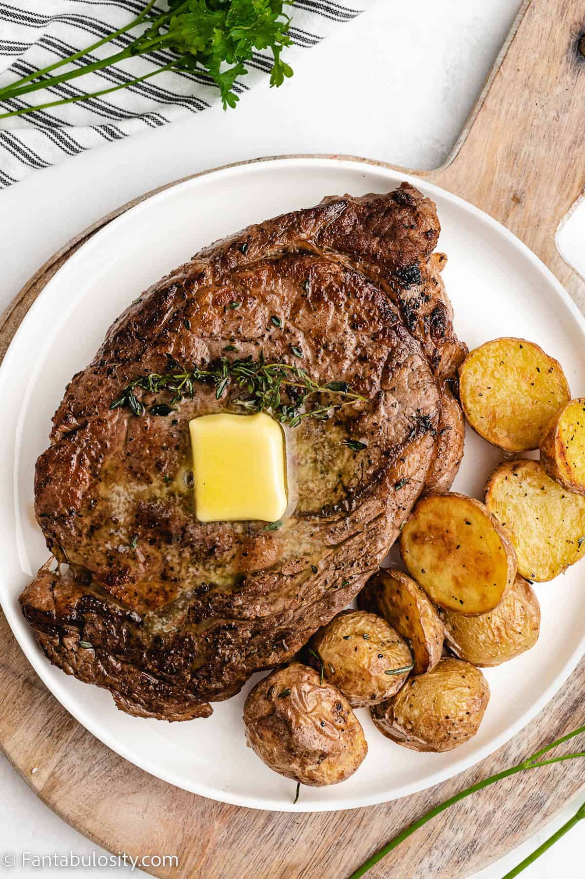 Butter melting on steak that was cooked in oven