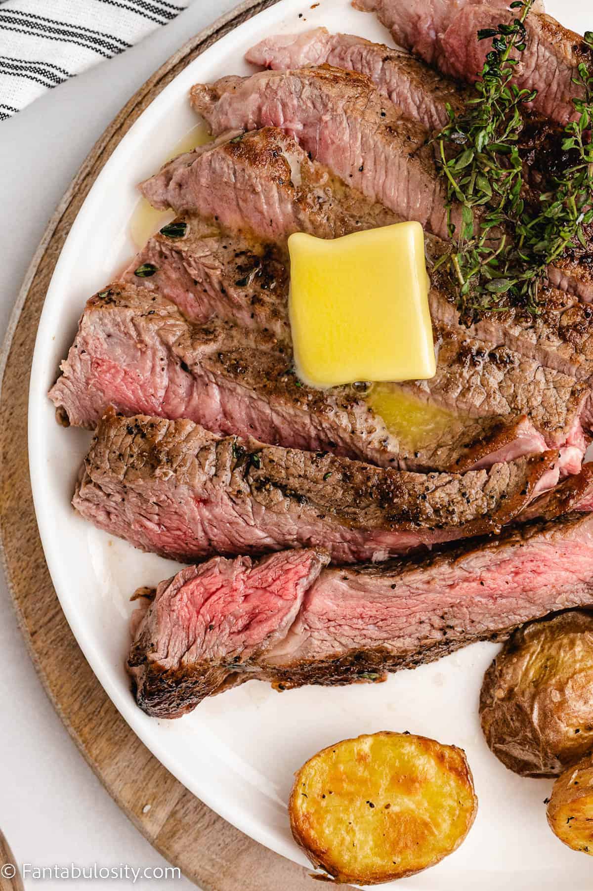 Sliced oven baked steak with butter on top