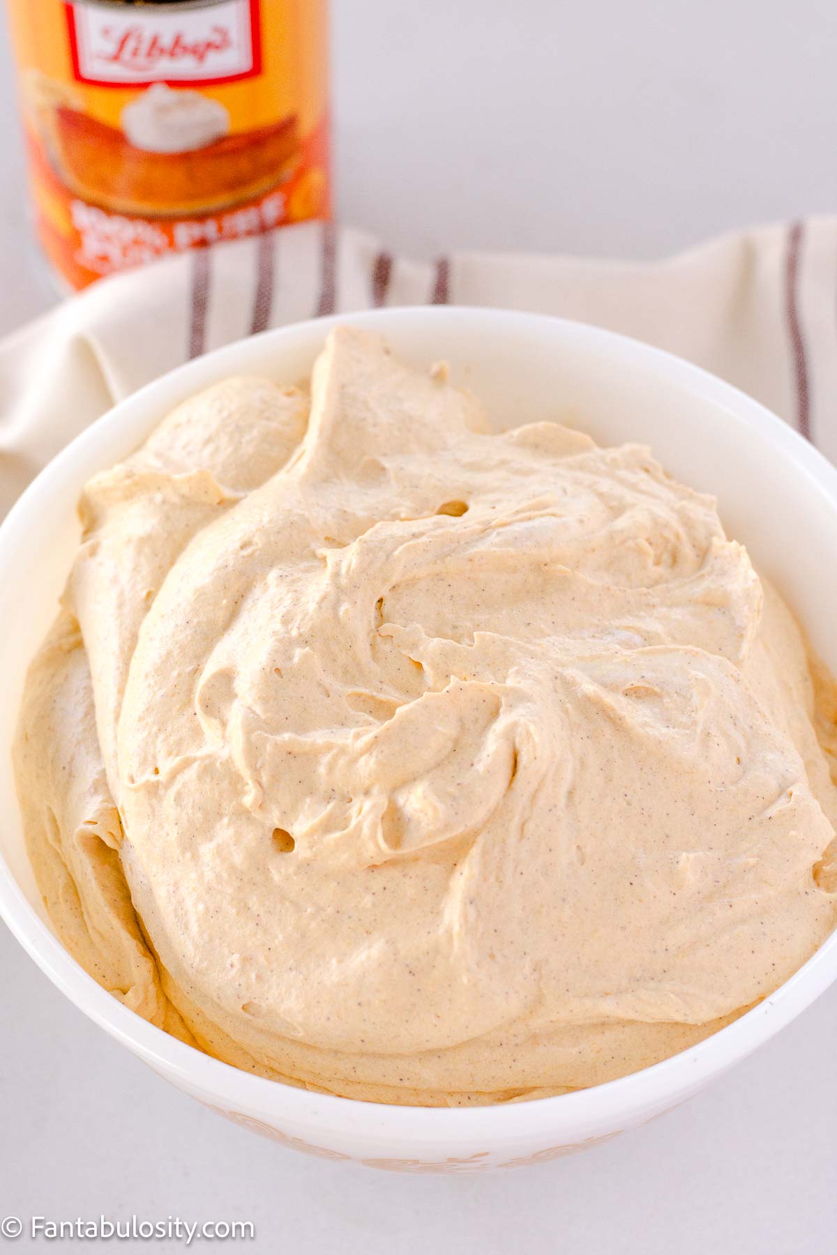 Cool Whip mixed in to pumpkin mixture, in mixing bowl.