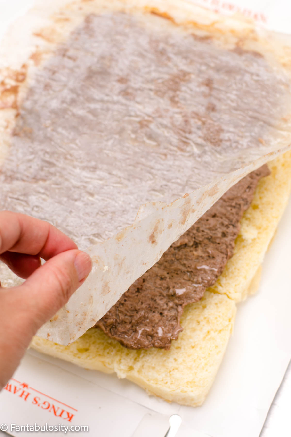 Remove parchment paper from ground beef square