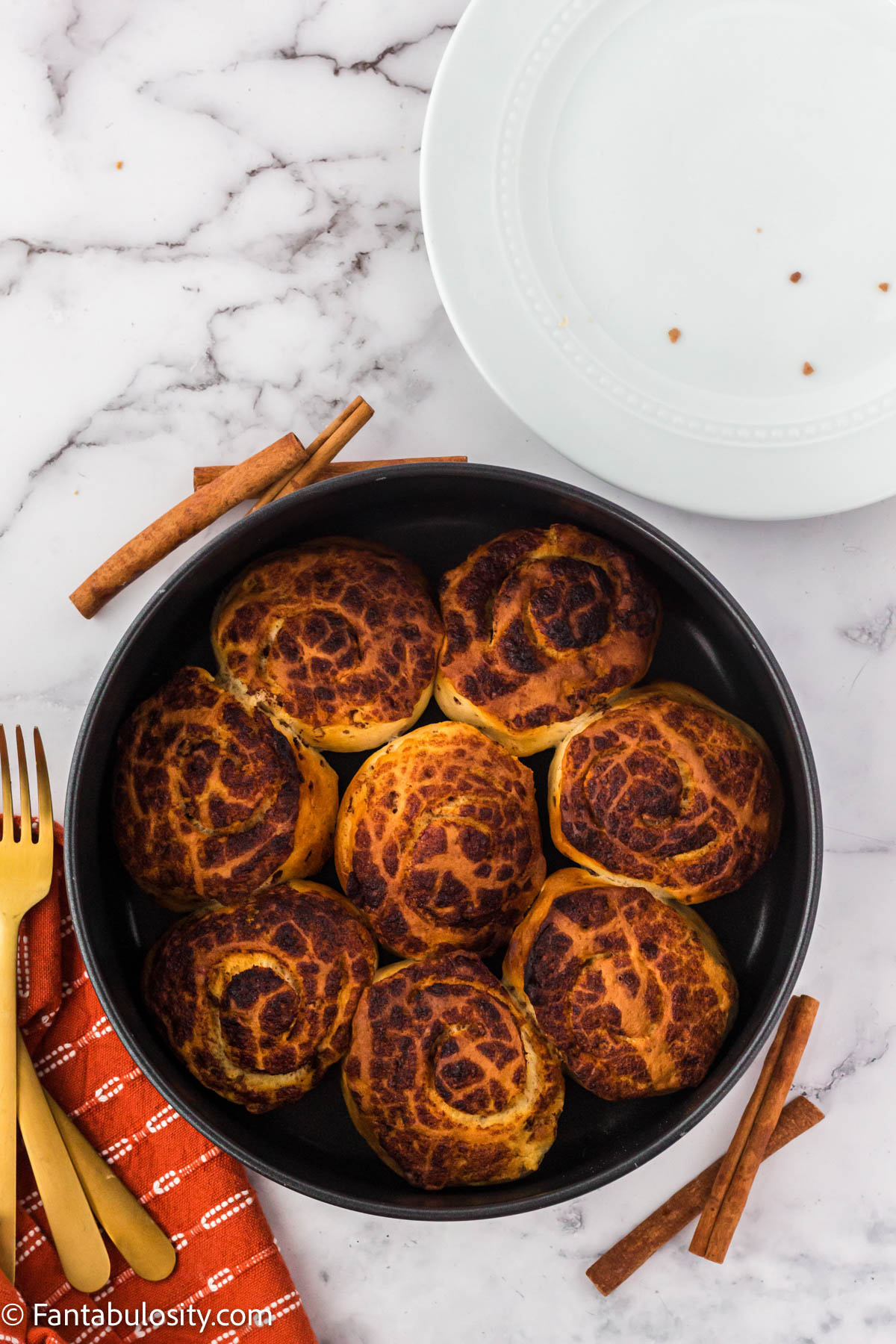 Cooked canned cinnamon rolls in air fryer basket