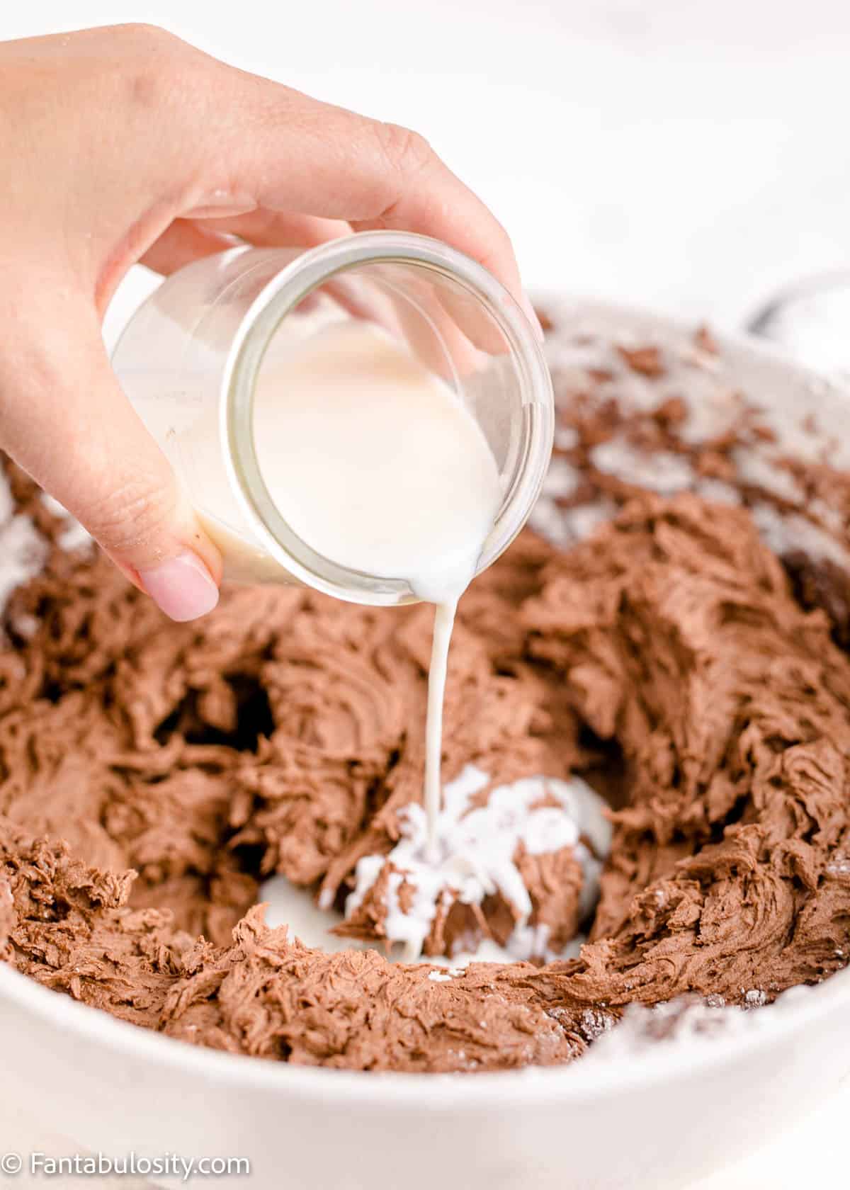 Pour in milk to frosting to thin