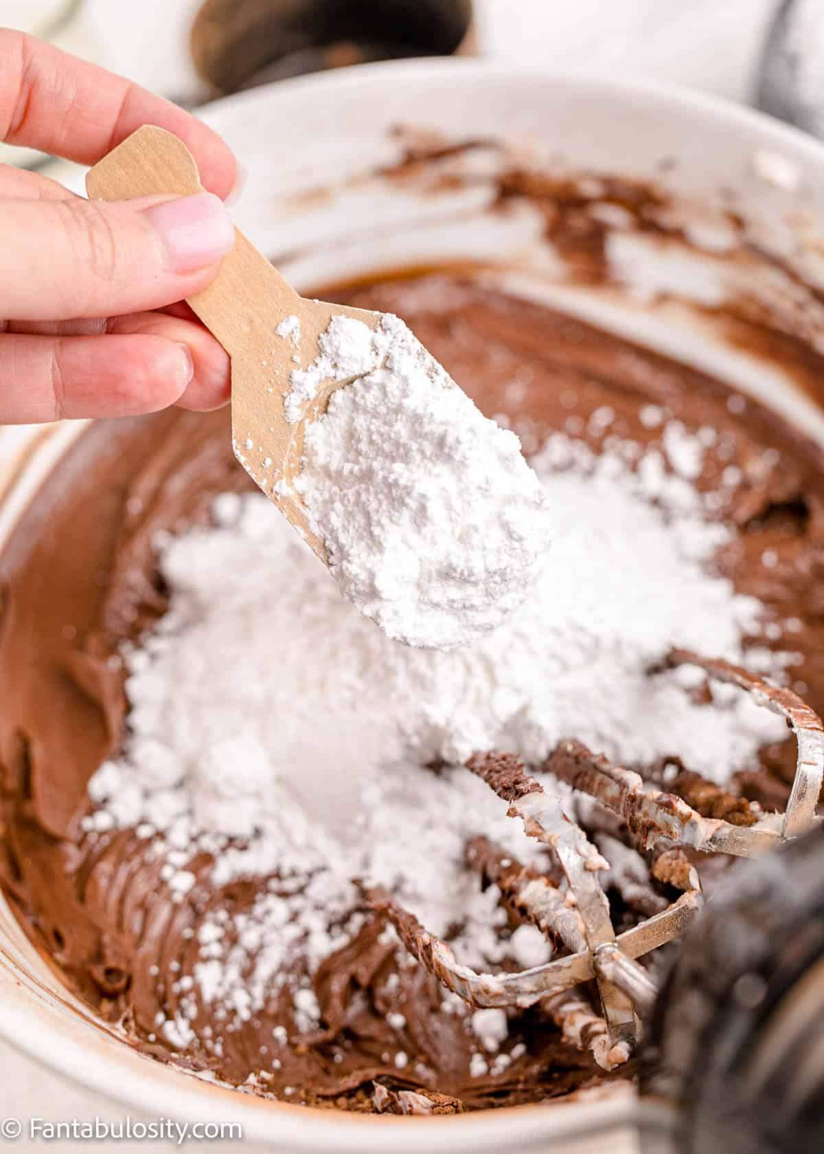 powdered sugar pouring in to chocolate