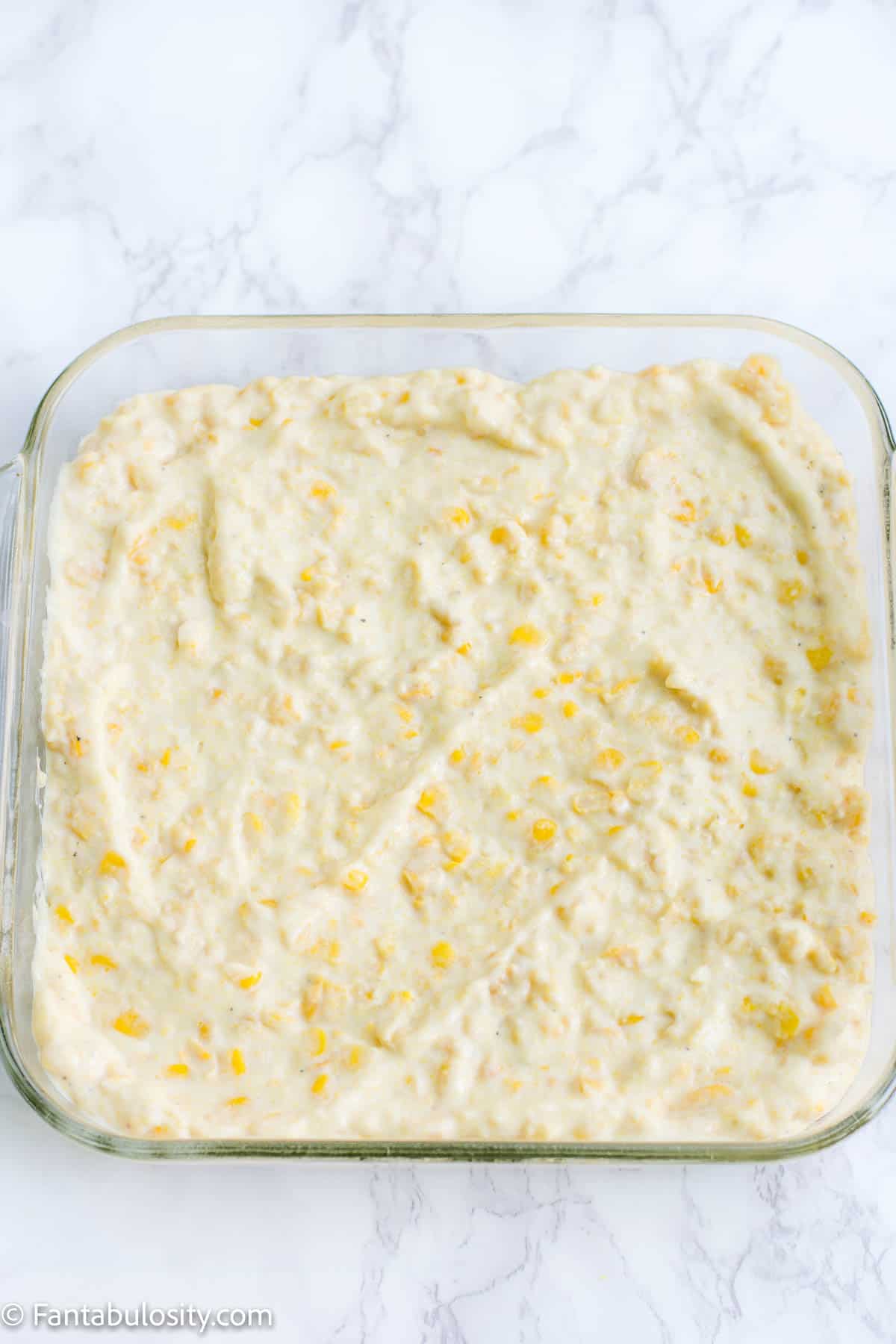 Corn casserole mix placed in greased baking dish
