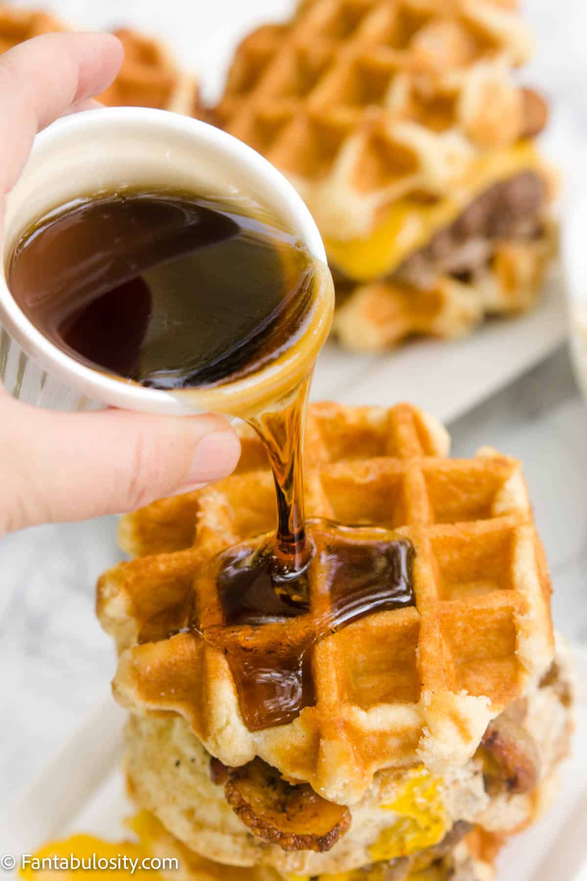 Syrup pouring on to waffle burger