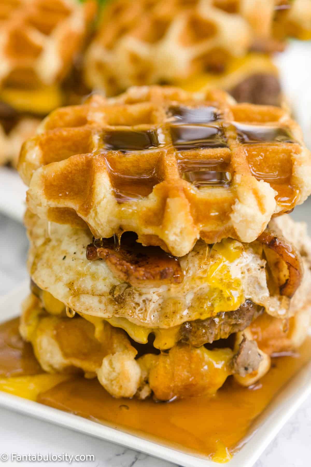 Syrup dripping down top of waffle burger
