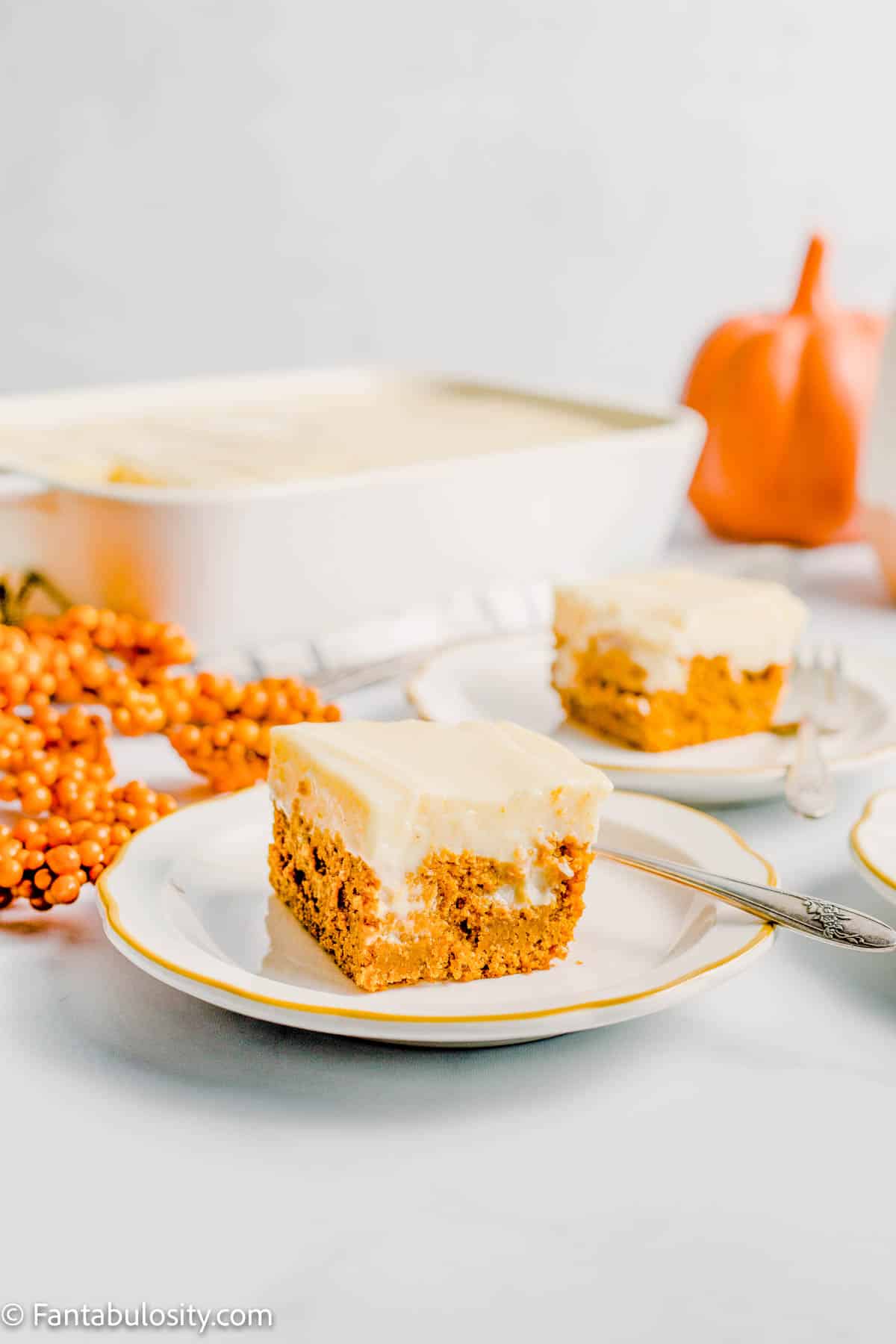 Sliced pumpkin poke cake on plate