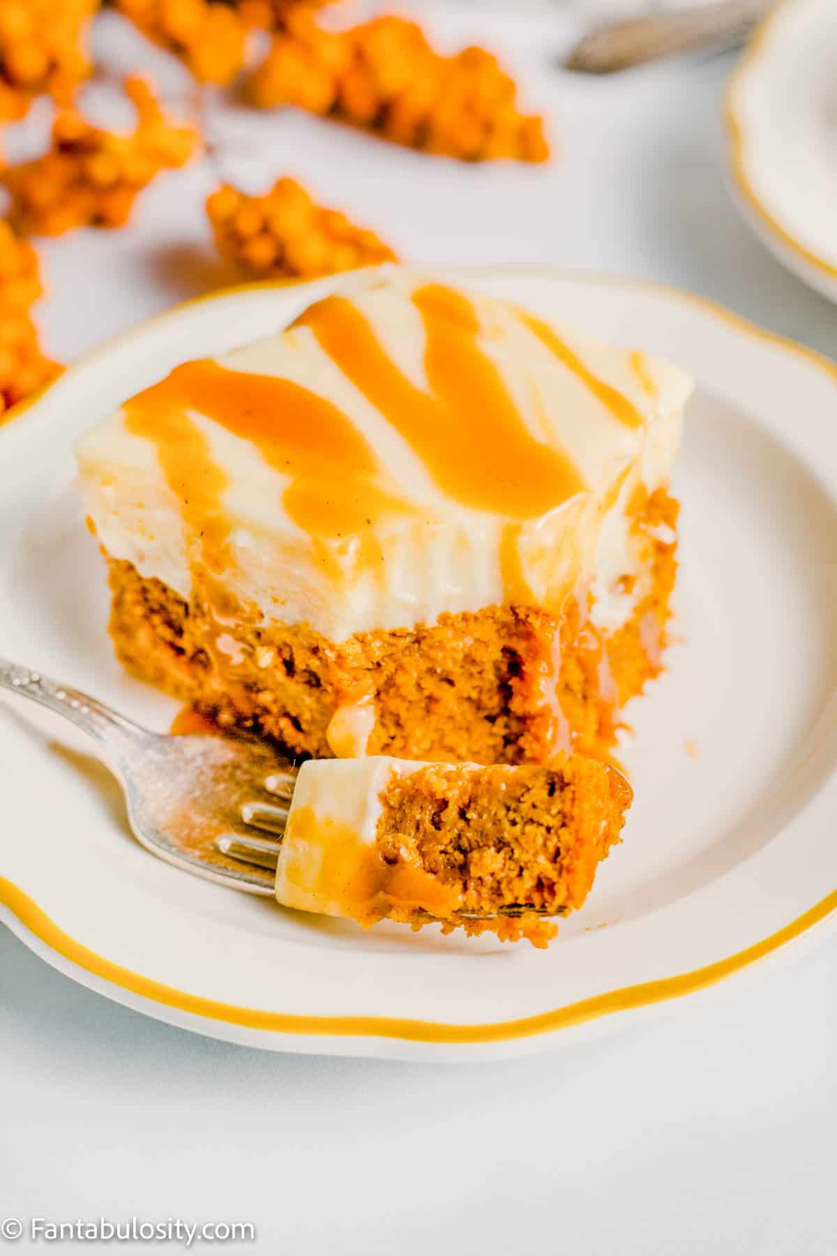 Pumpkin Poke Cake on Plate with bite on fork