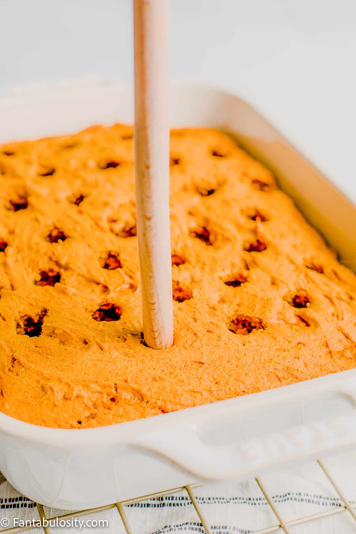 holes poked in to baked cake