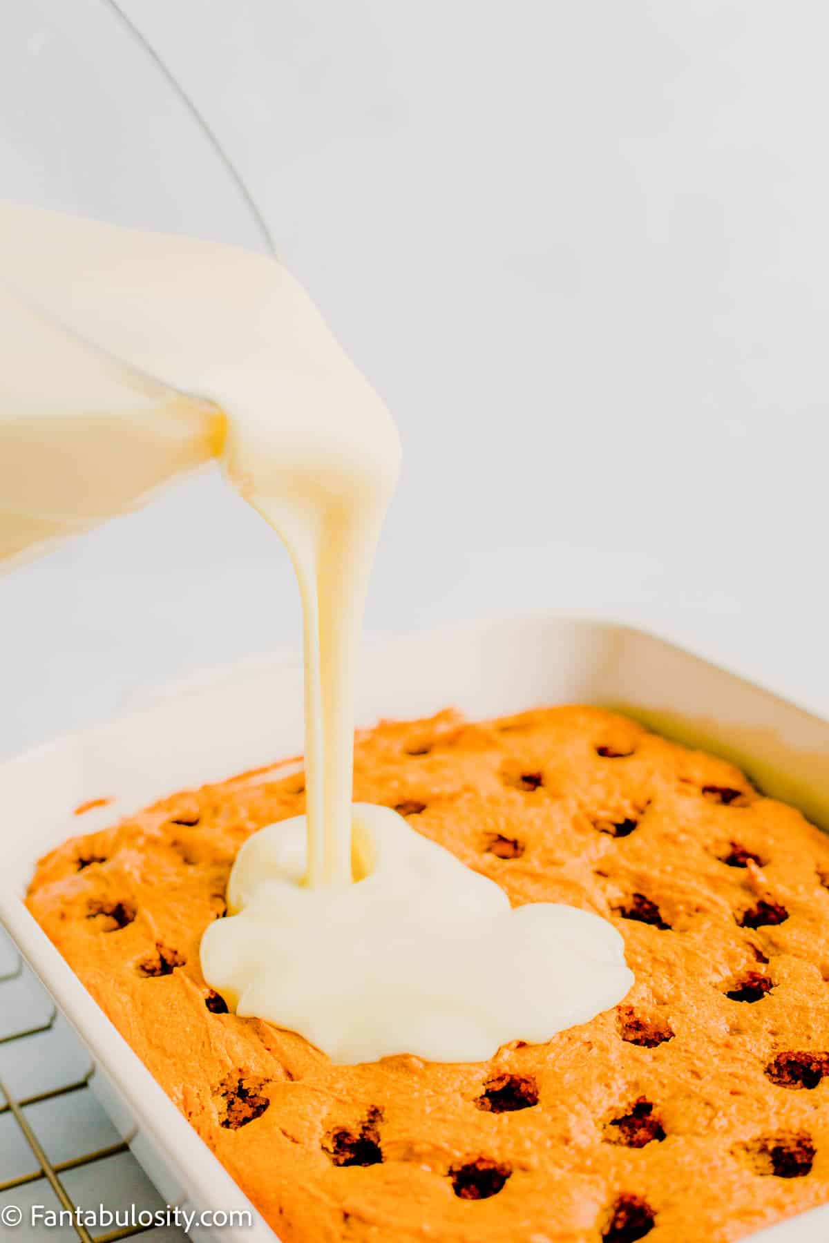 Pour pudding over the top of warm cake