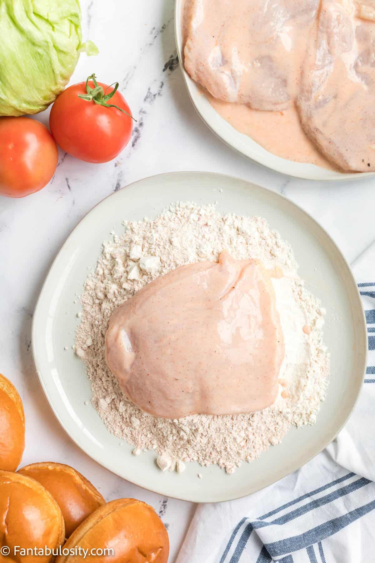 After dipping your chicken in the marinade mixture, coat it in the seasoned flour.