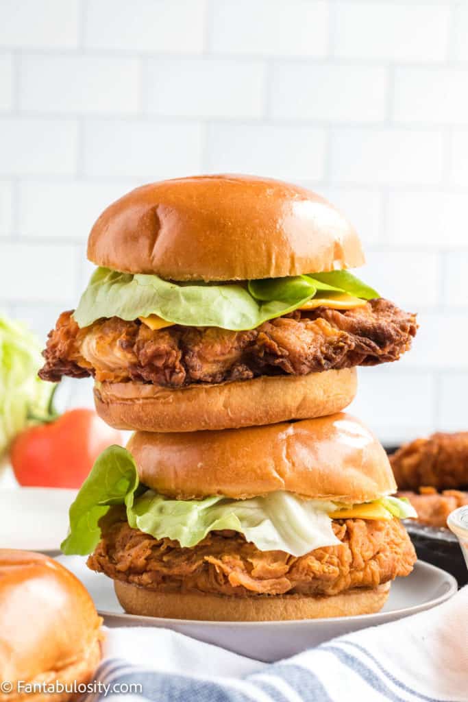 stacked zinger burgers with white background