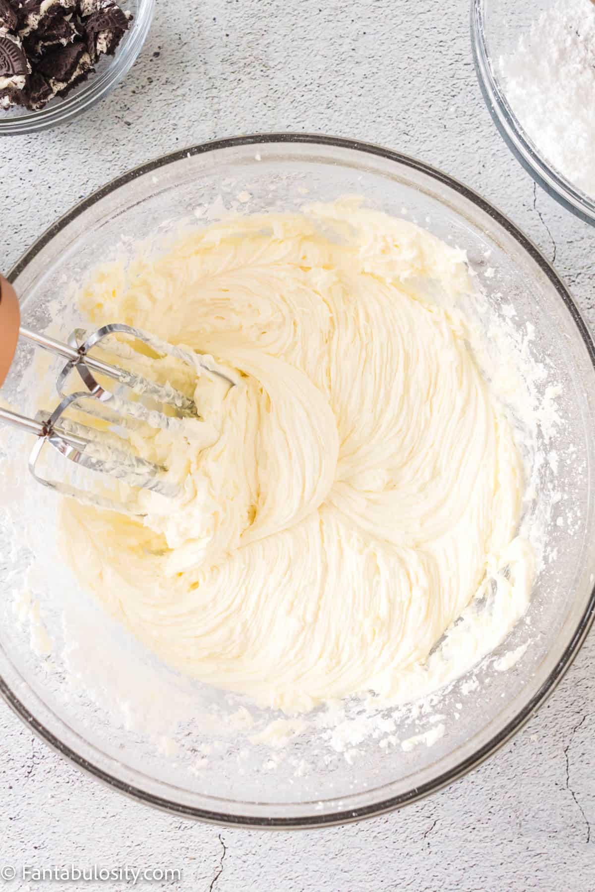 Butter and cream together in mixing bowl.