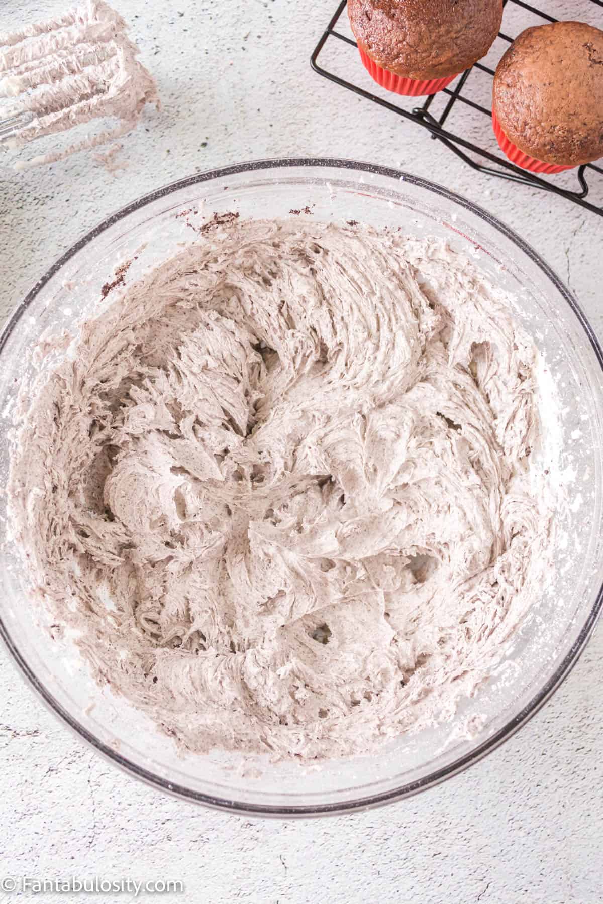 Cookies and cream buttercream frosting in mixing bowl.